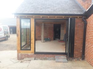 3 Aluminium windows and bifold doors into oak extension